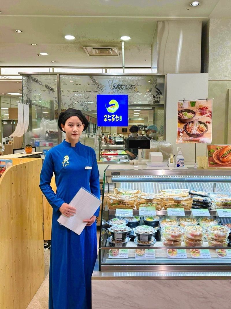 Staff welcoming a guest at a Viet Kitchen counter